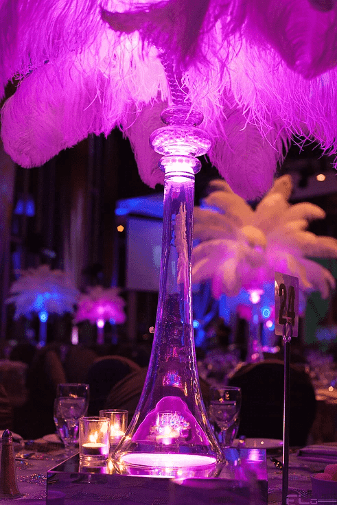 LED-lit glass vase and feather centrepiece with table number 24