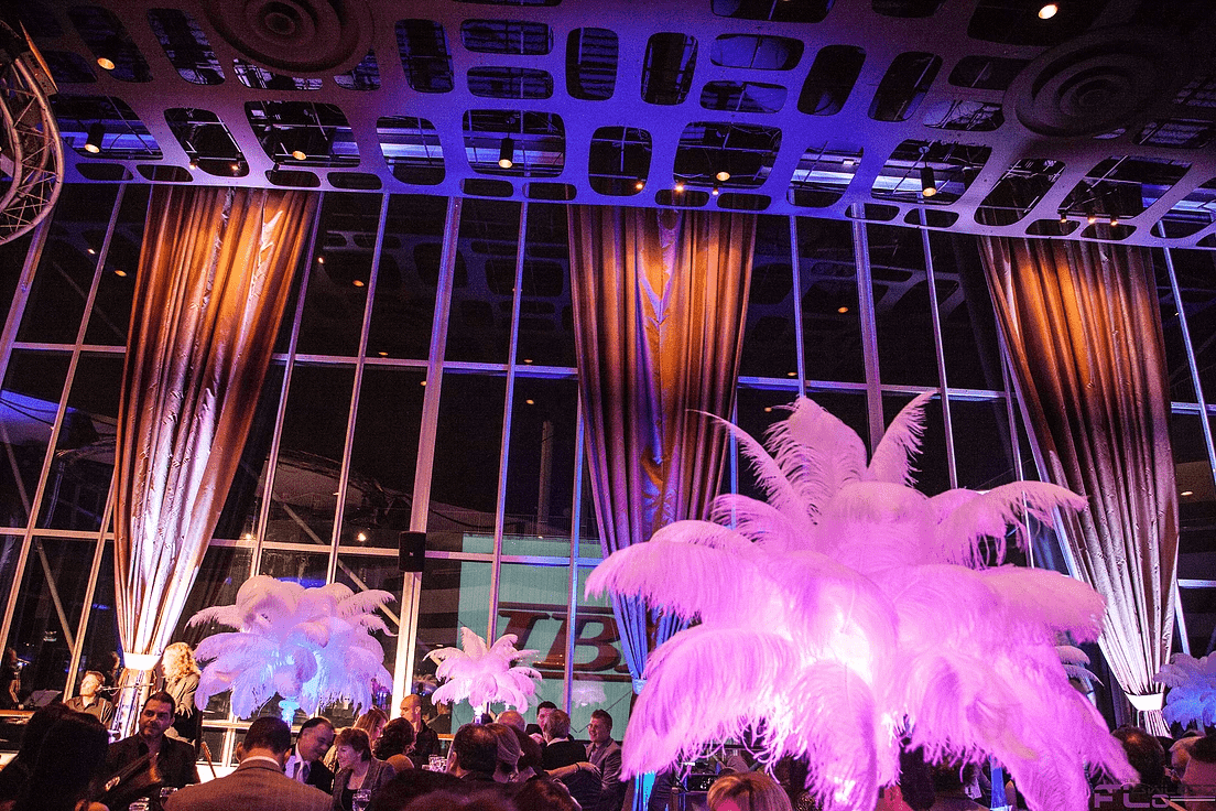 Lit feather centrepieces and drape swags in the glass hall at Atlantis