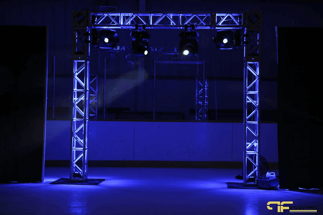 Blue-lit square truss arch with four moving heads at the arena players' entrance
