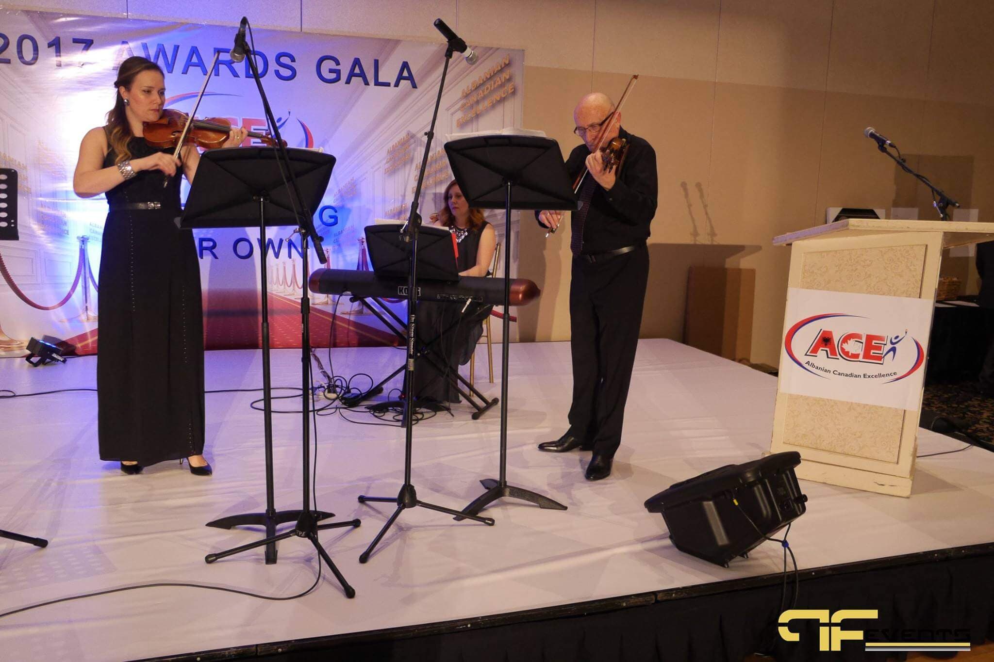 String duo with keyboard and music stands beside the ACE lectern