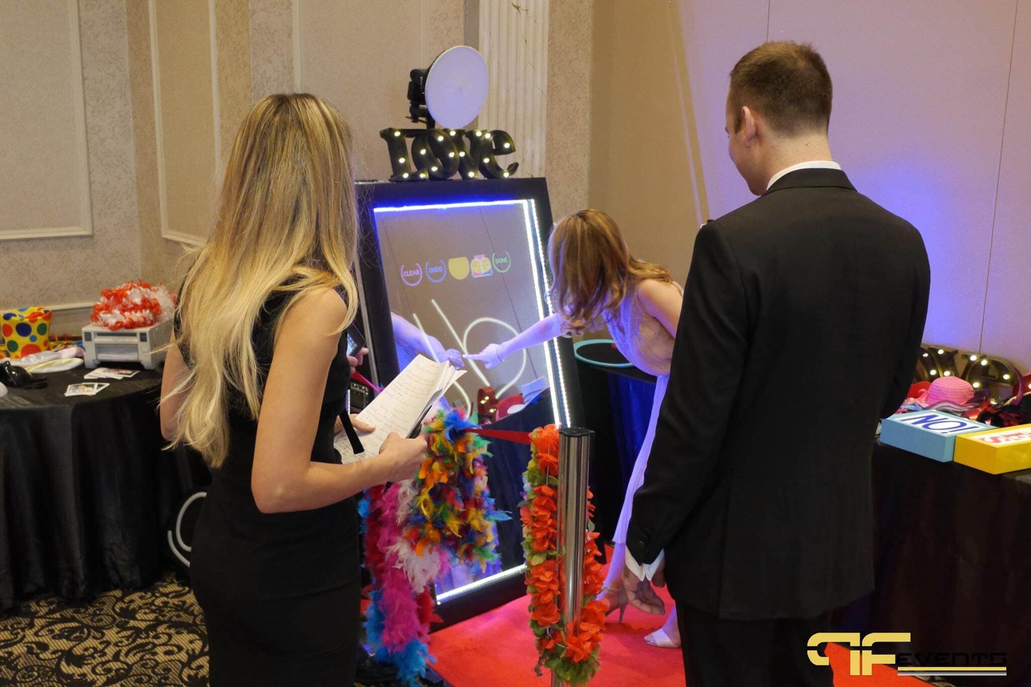 Guests using the magic-mirror photo booth at ACE Gala 2017
