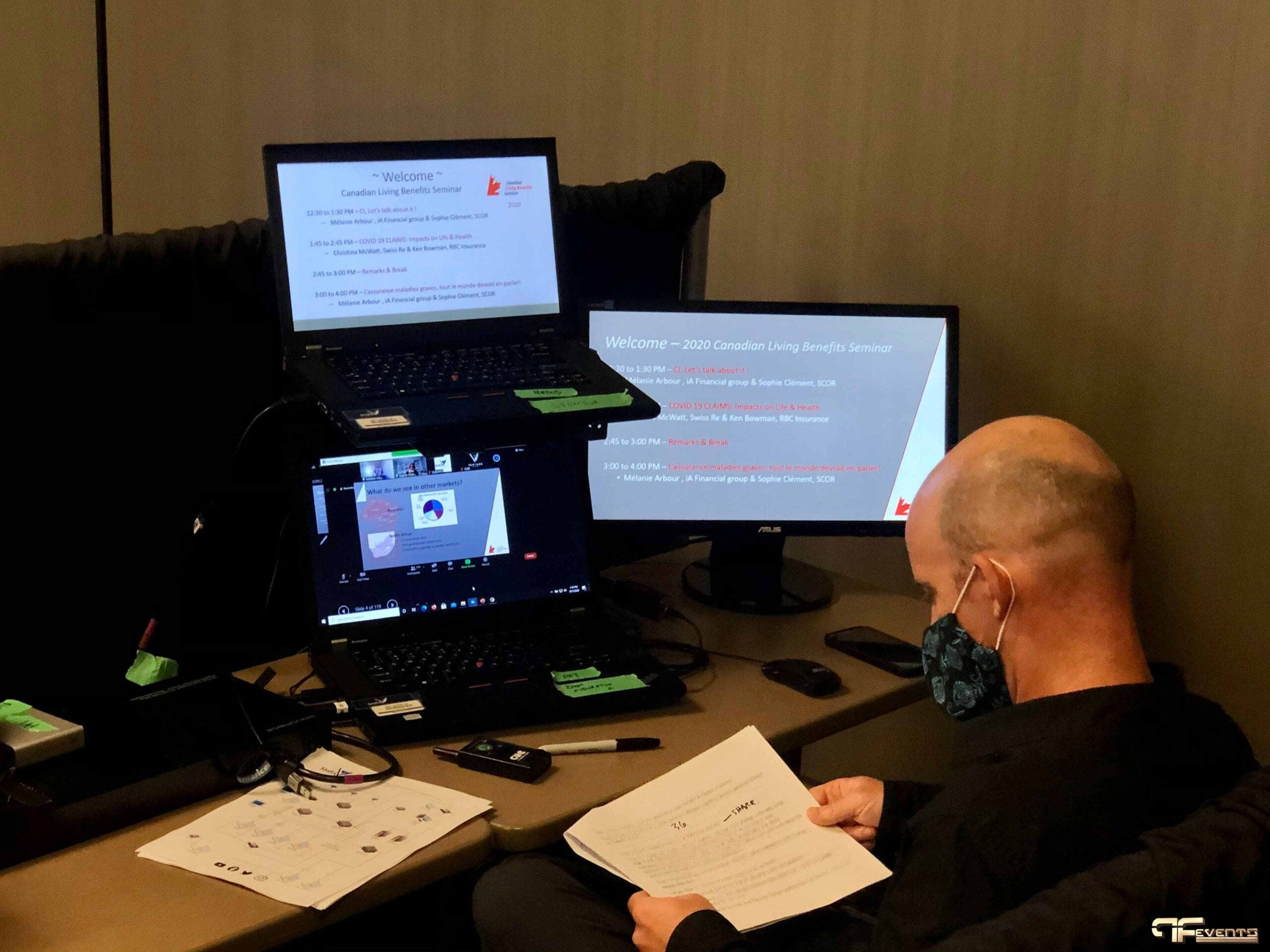 Technician reviewing the run sheet beside seminar welcome slides and Zoom