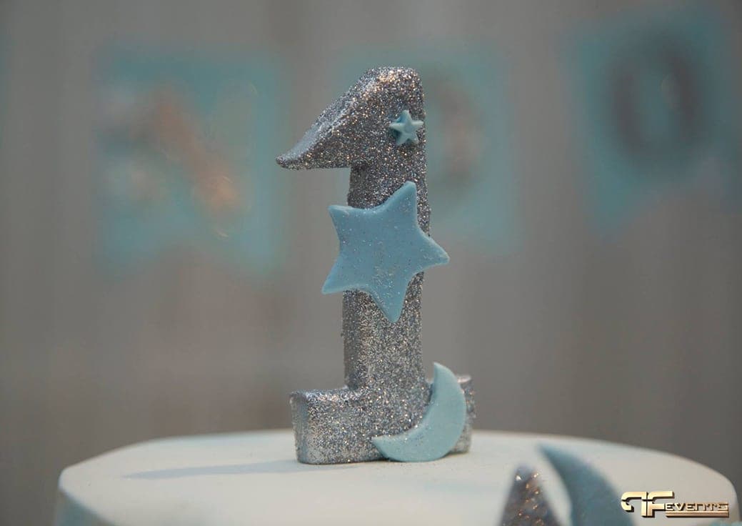 Silver glitter number-one cake topper with blue star and moon