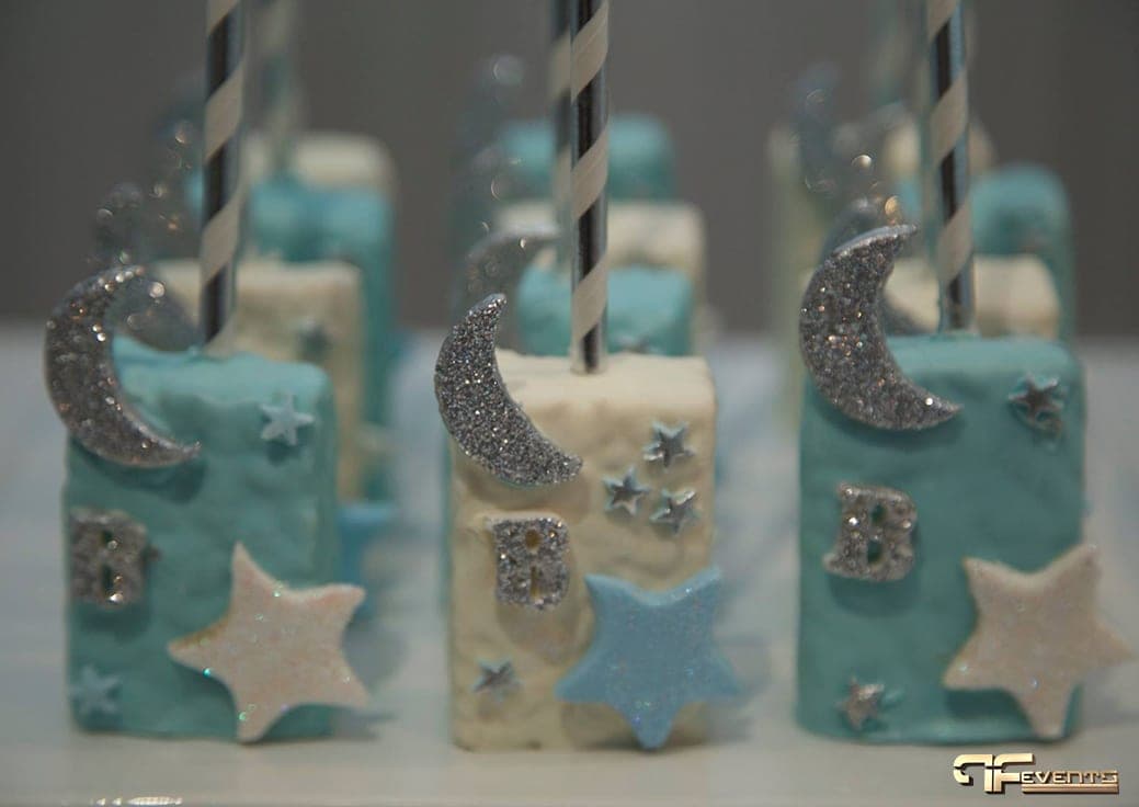 Blue and white dessert pops decorated with glitter moons and stars