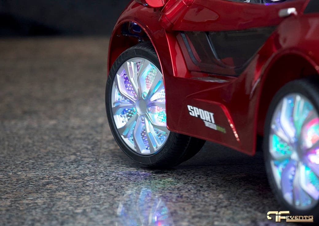 Light-up wheels on a red children's ride-on sports car