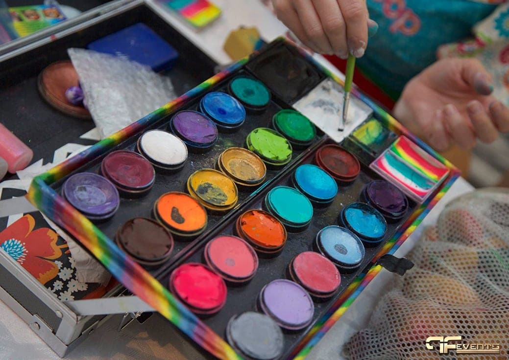 Face painter's palette of paint cakes at a children's party