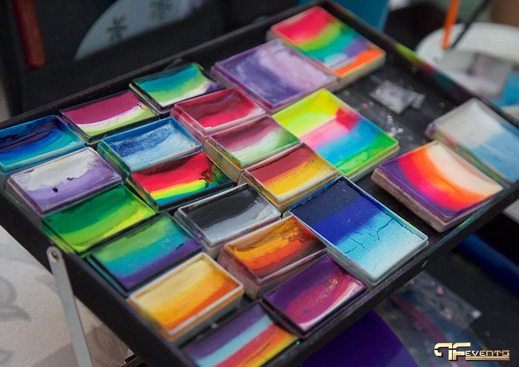 Tray of rainbow split-cake face paints