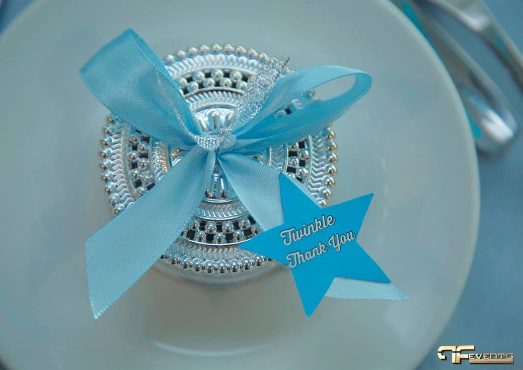 Silver favour jar tied with blue ribbon and a “Twinkle Thank You” star tag