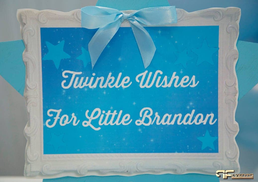 Framed blue “Twinkle Wishes” sign with a satin bow on the dessert table