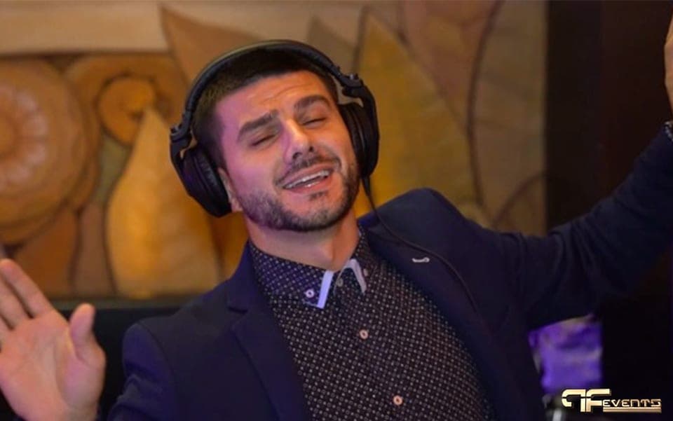 Performer in headphones singing along at the IBX gala