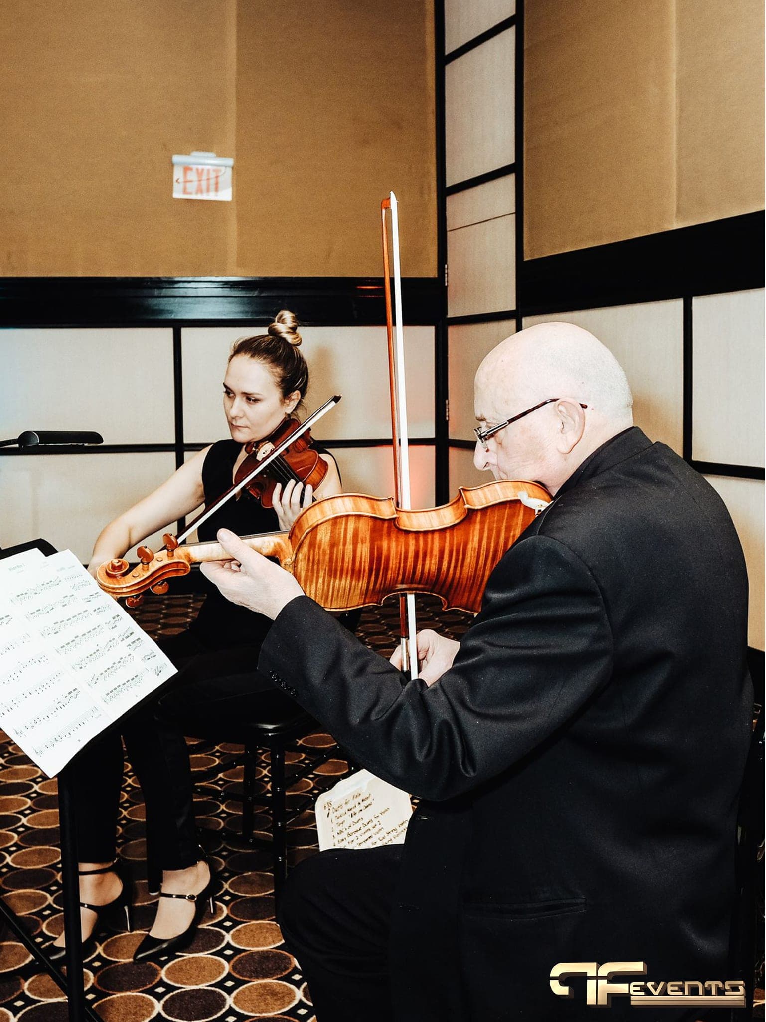 Violin and viola duo playing a foyer reception at the IBX gala