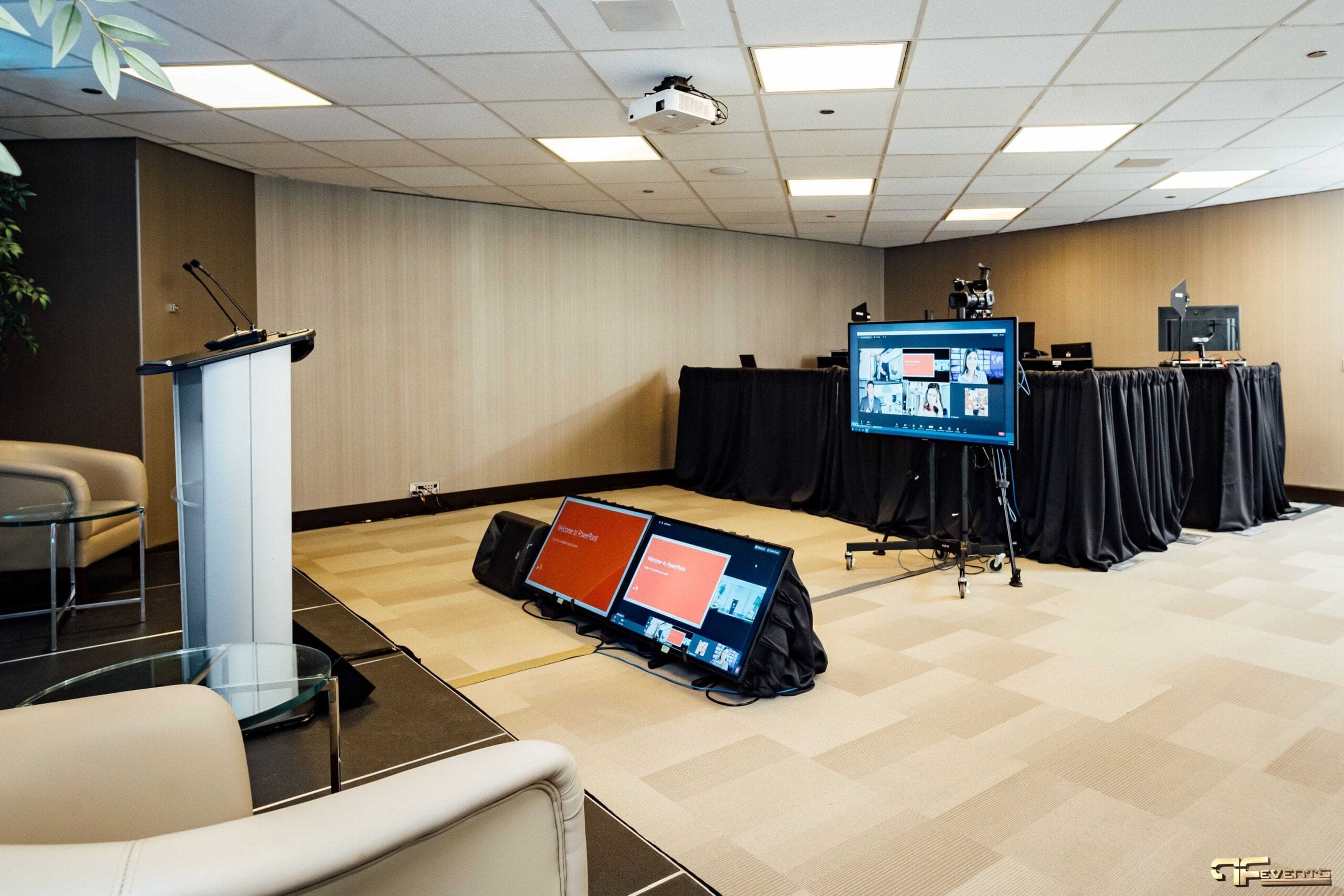 Virtual studio floor with lectern, confidence monitors and a Zoom gallery screen