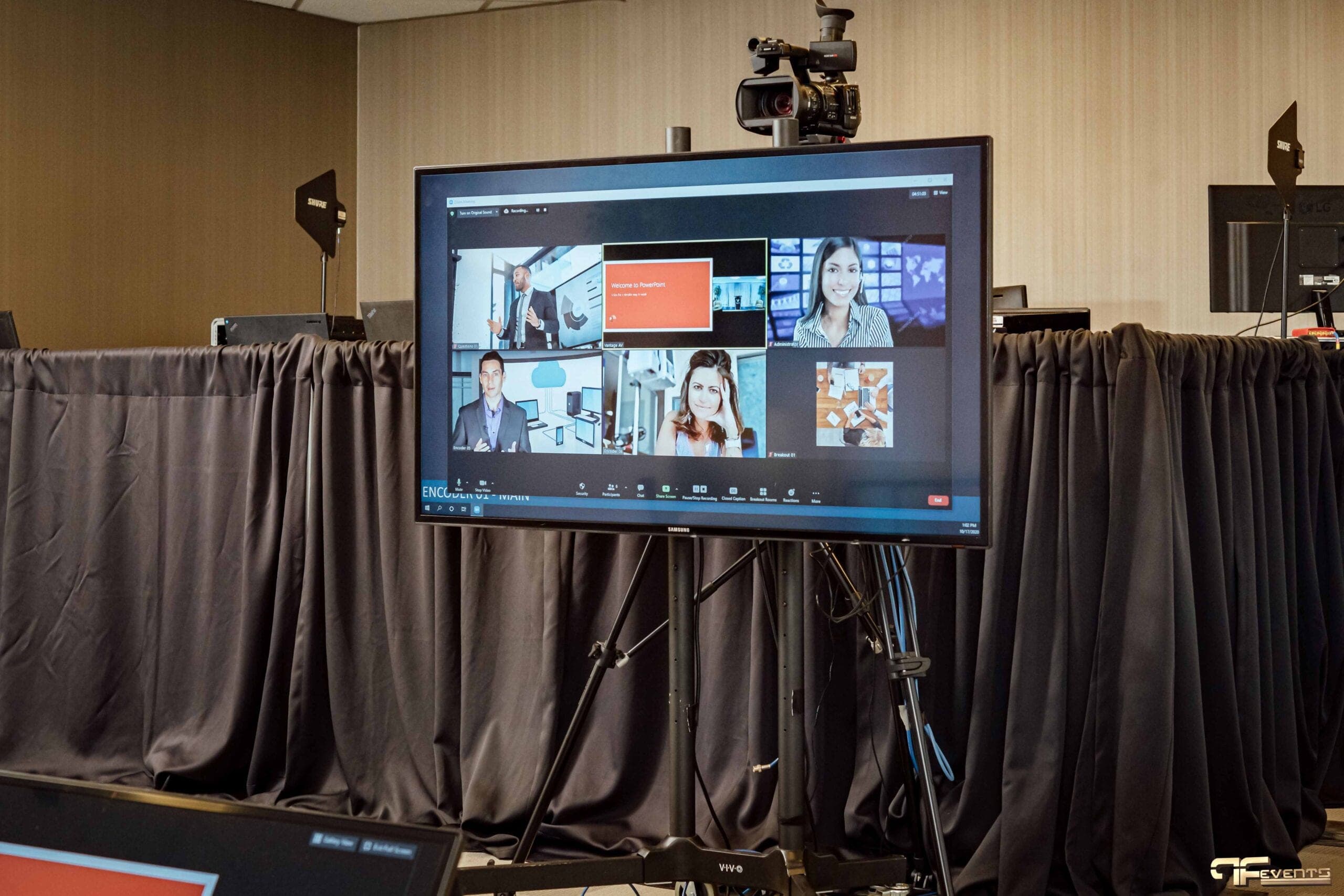 Zoom gallery on a stand-mounted display with a camera on top, Shure antennas