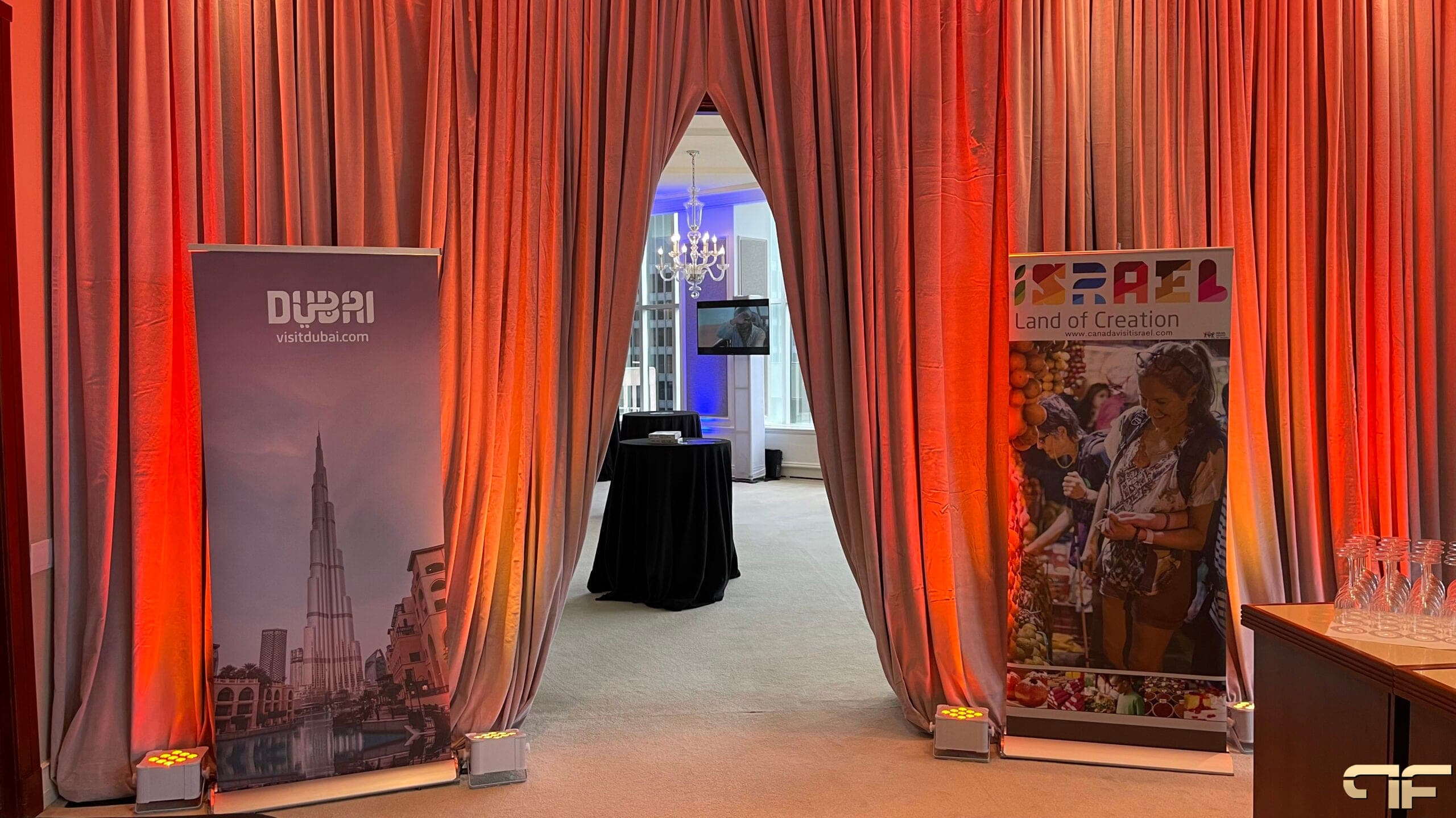 Visit Dubai and Israel Land of Creation banners flanking an uplit drape archway