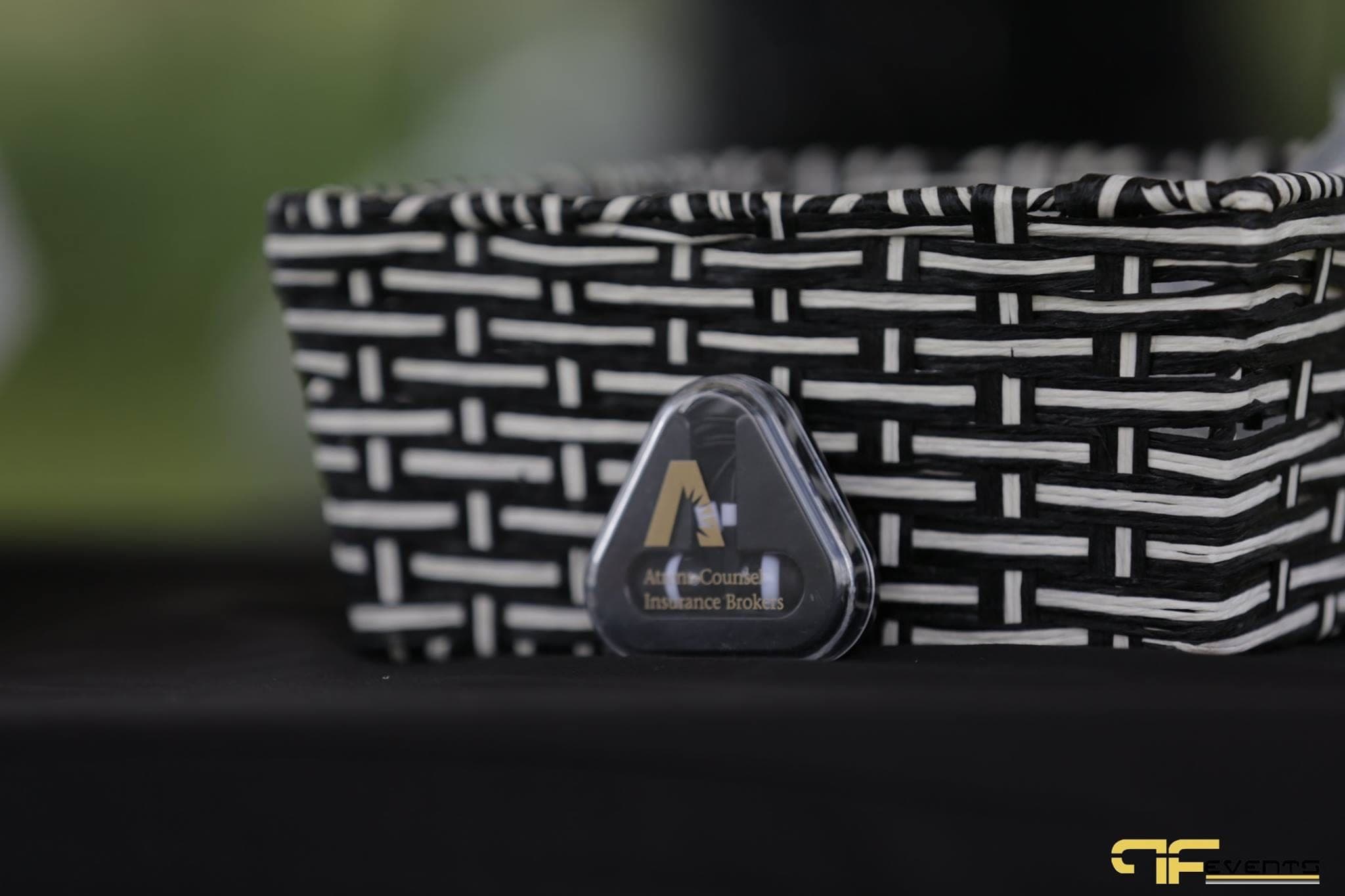 Sponsor giveaway beside a black-and-white woven basket