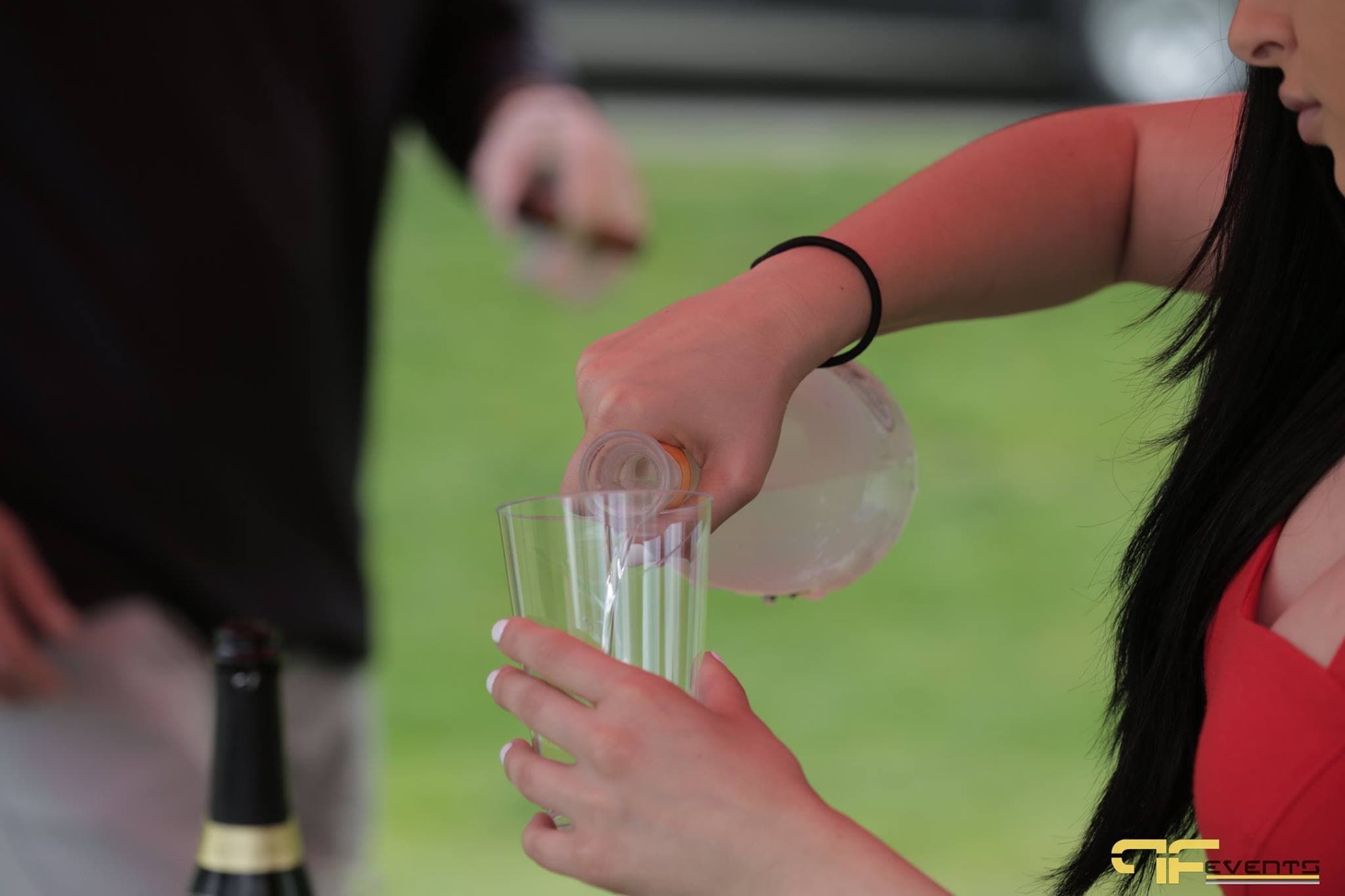 Server pouring a drink at an on-course hospitality station
