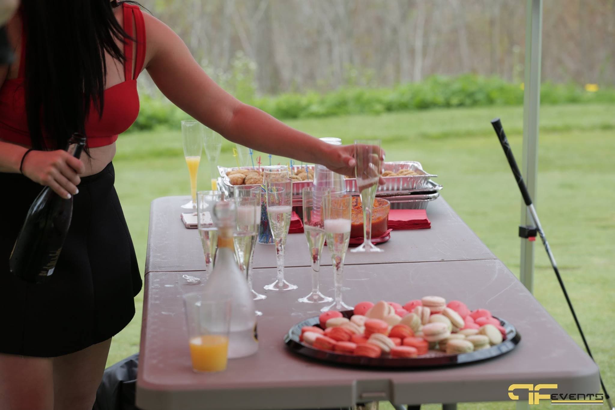 On-course hospitality table with sparkling wine, macarons and appetisers