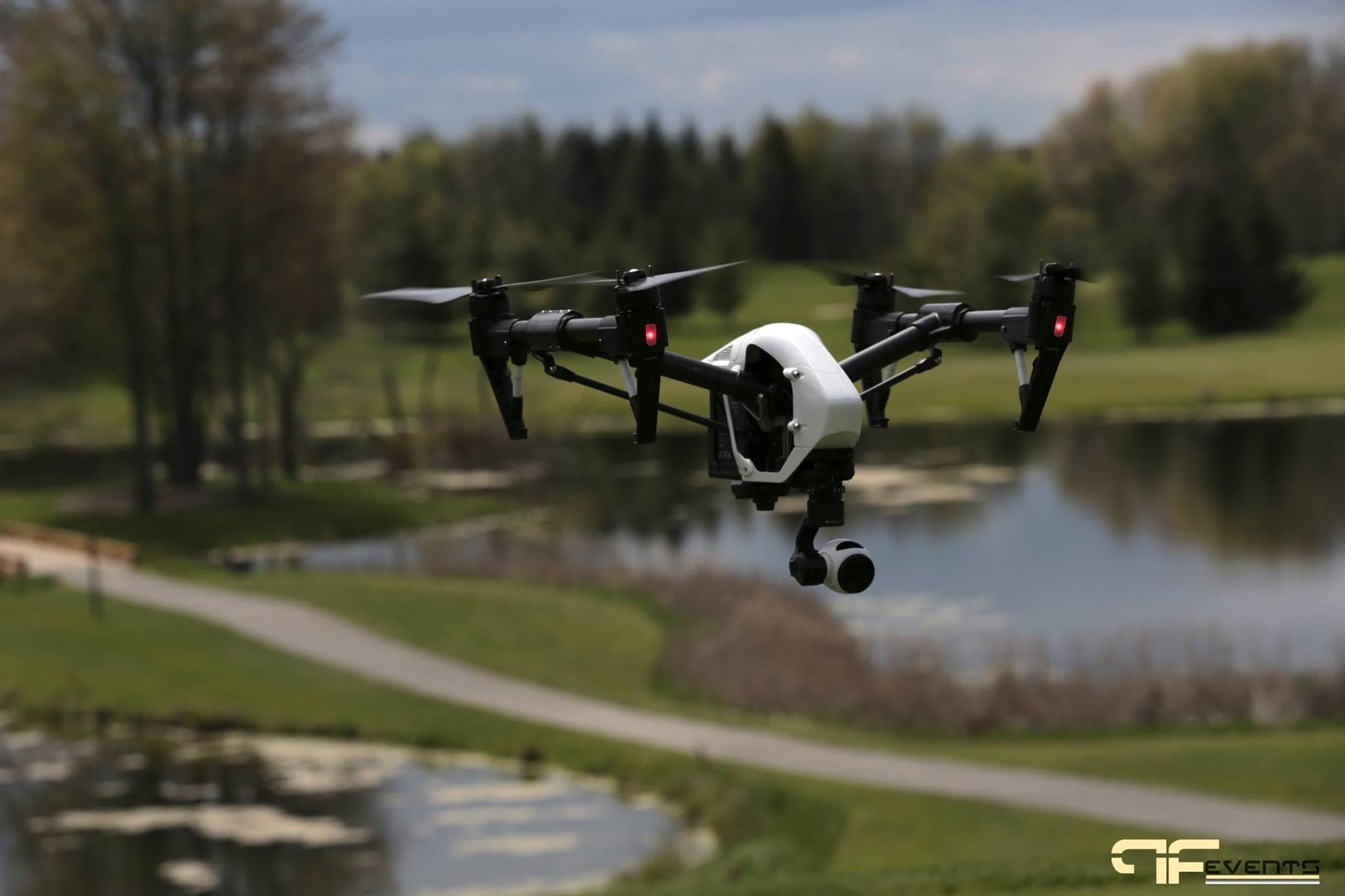 Camera drone hovering over a pond on the golf course