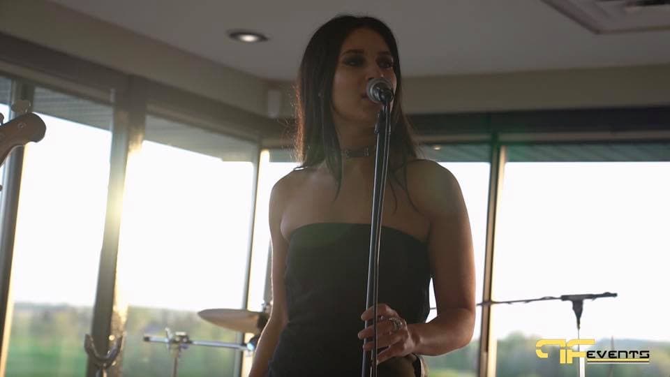 Singer performing in the clubhouse at golden hour