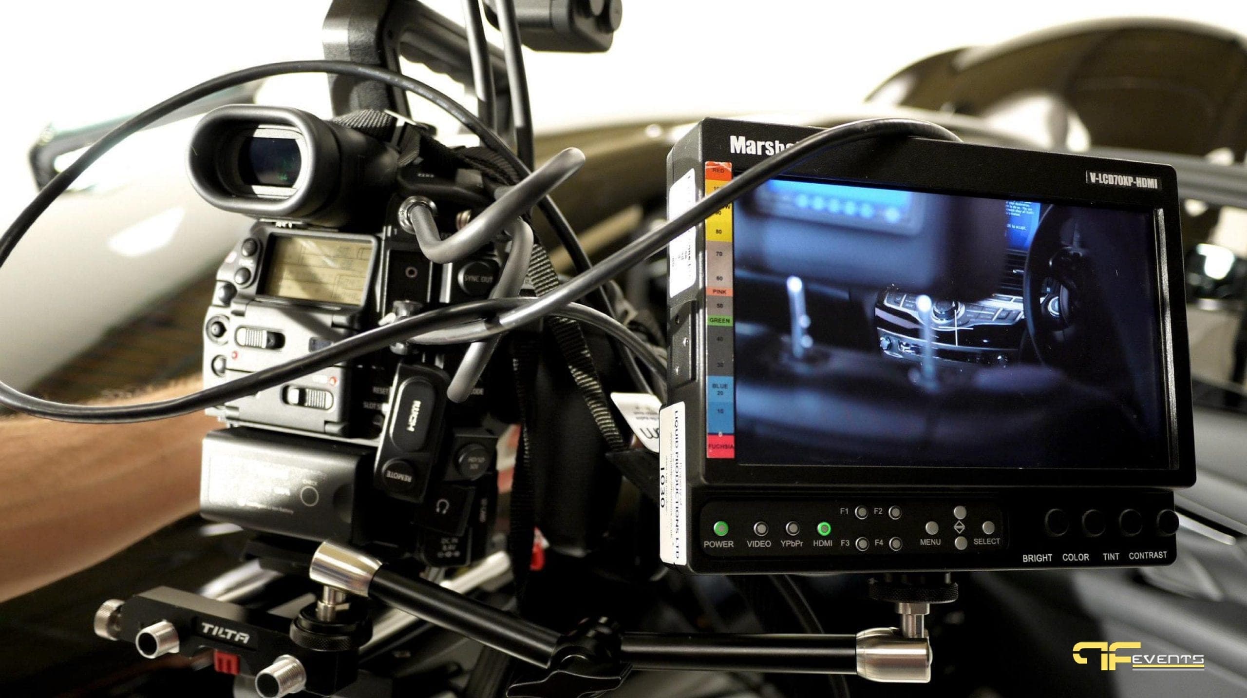 Camera rig with an on-camera monitor framing a car interior during a product video shoot